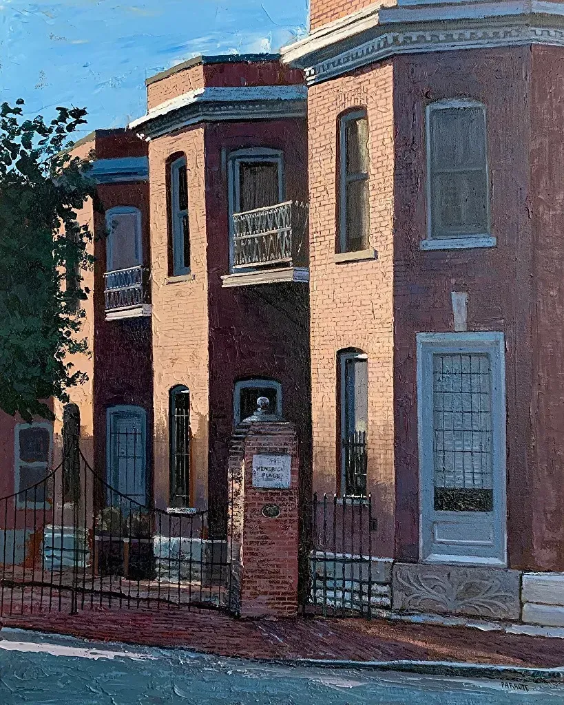 Late sun raking across a brick row house: iron balconies, deep window reveals, a gatepost lettered Kendrick Place, long shadows down the pavement.